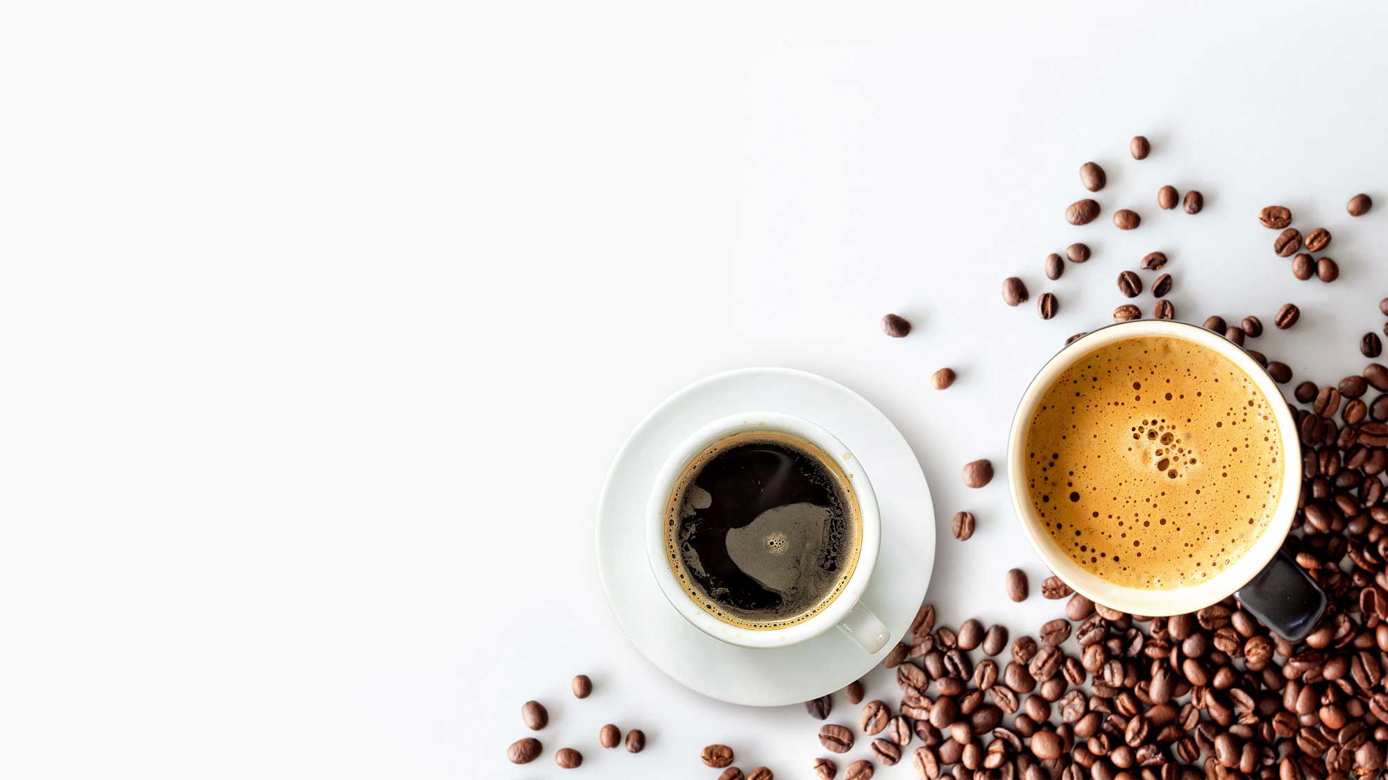 Coffee espresso cup and coffee beans around it